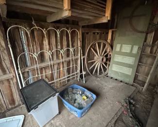 Wagon wheels. Tongue and groove wainscot. Wrought iron antique bed
