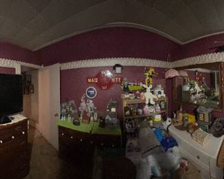 Bedroom full of craft supplies and antique wall hangings