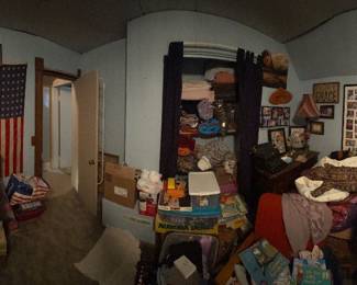 Bedroom with quilts, bedding, signs and furniture