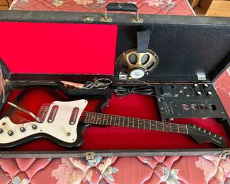 1960s SILVERTONE 1452 Hornet electric guitar featuring a red sunburst finish and a matching amplifier built into the case