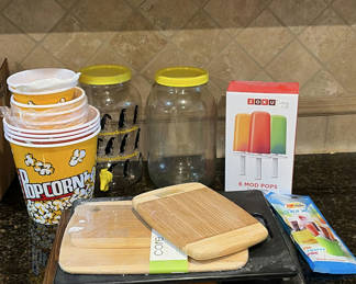Lot 252: Kitchenware assortment: bamboo cutting boards, glass jars, popcorn tub, and ice pop molds