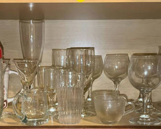 Lot 242: Assorted glassware and mugs on cabinet shelf
