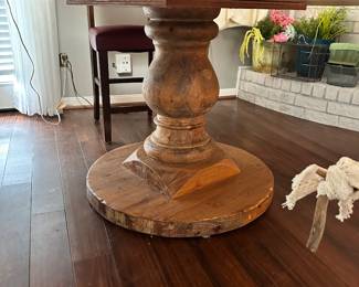 Couldn't find a brand, lovely spindle bottom w/wooden top covered in distressed steel. 