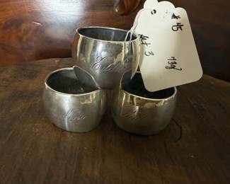 Item 45 800 silver 73g $121.00 set 3 antique napkin rings with dents and engraved with Nina, Paul and Eddie