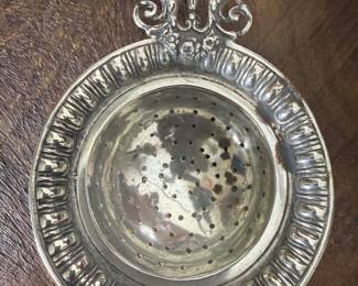 Item 76 unmarked tea strainer discoloration on finish $ 30.00