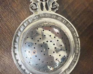 Item 76 unmarked tea strainer discoloration on finish $ 30.00