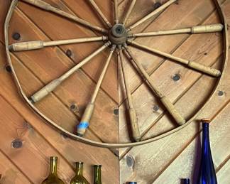 Wagon wheel and colored bottles