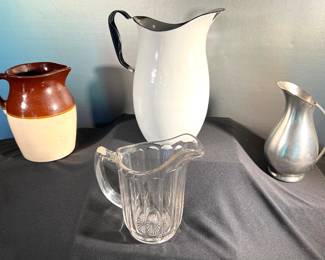 Stoneware pitcher, ribbed glass pitcher, farmhouse style enamelware and small pewter pitchers