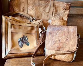 Tooled leather purses, one with horse emblem 