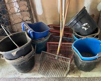 Many feed buckets, hay rakes