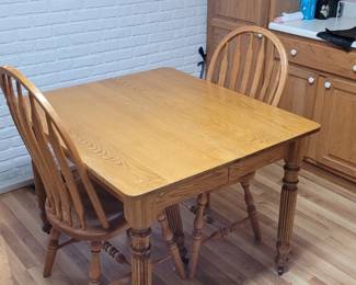 Oak table and two chairs. 36 in by 36 in with 5 leaves