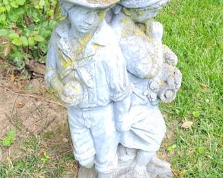 Cement boy and girl lawn ornament 