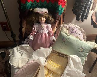 Old pillows and baby clothes in a rocker.