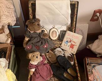 Sweet collection of children items, bears, shoes, books, in a small trunk.
