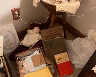 Doilies and a wooden bowl on a stand, and baby items.