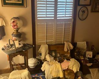 Another display in Lottie's room with her collection of thimbles, baby clothes, doilies, sewing notions and books.