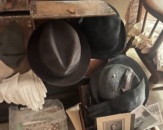 Miscellaneous photos, hats, gloves, hosiery for the era long ago, found inside the trunk.