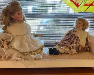 American girl dolls on doll bed