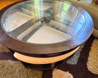 American Signature Round Coffee Table with Glass Insert and Upholstered Accent Band, $175