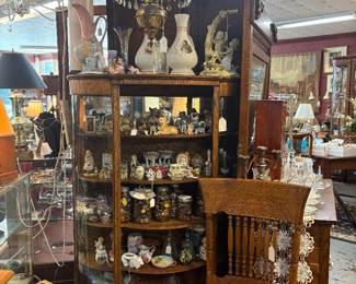Curio cabinet of figurines of animals, porcelain glass candy animal boxes buttons hand-painted items. Curved to glass cabinet with cloth feet middle door needs glass.