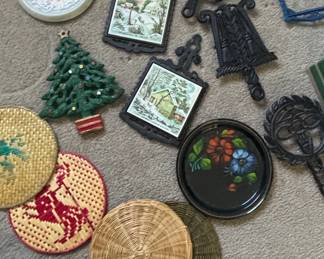 Vintage Cast Iron Trivets with Scenic Inserts, Ceramic Christmas Tree, Enameled Tray, and Woven Coasters