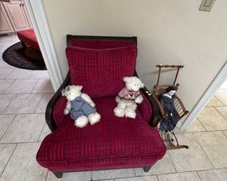 A beautiful Barry colored chair with two adorable bears in right next to it is an antique doll carriage with a antique porcelain doll that you’re going to want to put right beside your head when you go to sleep  