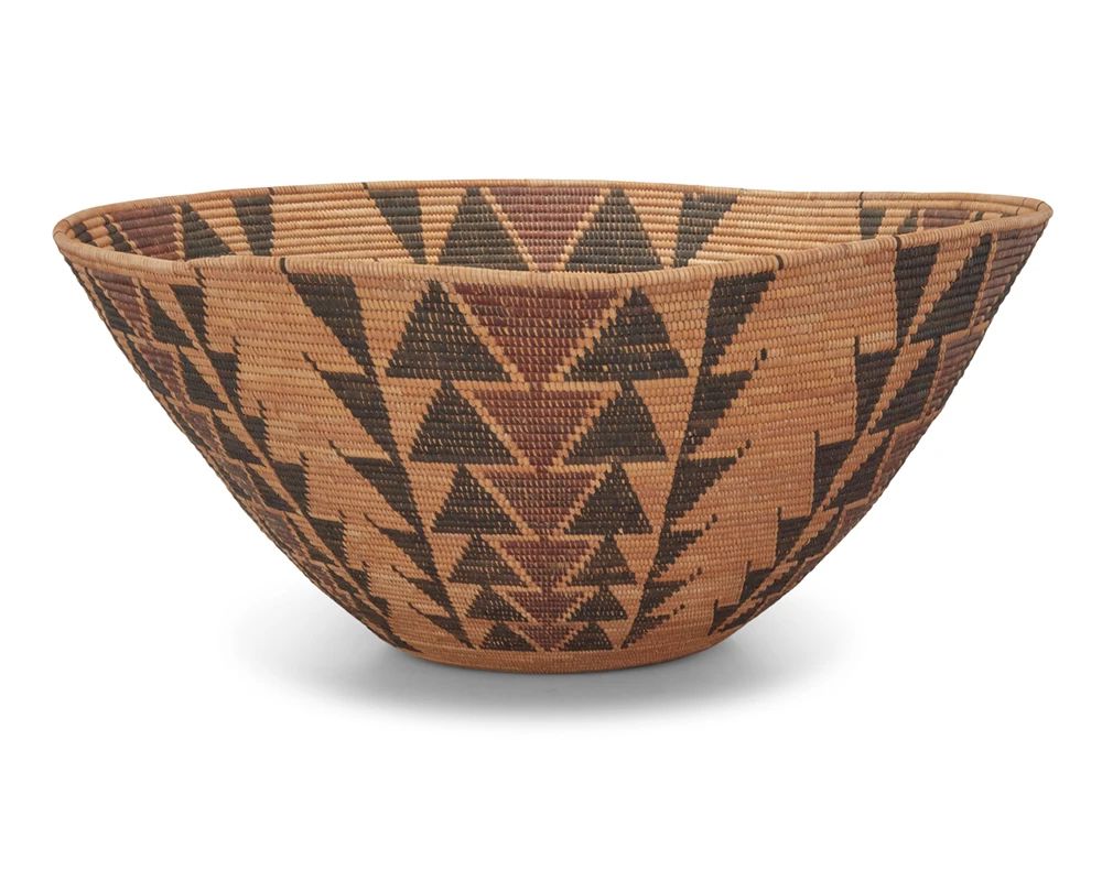 1001 A large Yokuts polychrome basketry bowl Early 20th century; Central California The coiled bowl with six graduated stacked diamond columns on a bundle foundation 10.5" H x 24" Dia. Estimate: $2,000 - $3,000