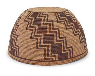 1012 A Mamie Gregory Panamint Shoshone polychrome basketry hat Mamie Gregory (1867-1947, Panamint Shoshone) Early 20th century; Great Basin The coiled hat with partial rim ticking above five stepped radiating arms issuing from center 4" H x 7.625" Dia. Estimate: $1,000 - $1,500