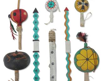 1385 A group of Hopi Pueblo polychrome dance implements Mid-20th century Comprising five painted wood or gourd rattles, two carved wood lightning sticks, and a carved wood dance rod, some mounted with feather accents or hide 7 pieces Longest rod: 21" L x 1.25" W x 0.375" D; Longest rattle: 17" L x 4.625" Dia. Estimate: $200 - $400