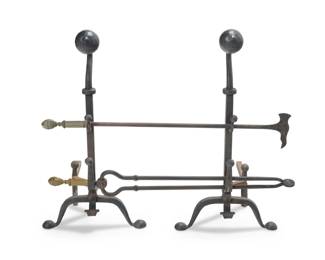 1189 A group of wrought iron fireplace articles Early 20th century Comprising a pair of hammered wrought-iron andirons, each with two hooks at front, and two brass and wrought iron fireplace tools including a poker and tongs 4 pieces Each andiron: 29.25" H x 15.25" W x 17.25" D; Longer tool: 35.25" L Estimate: $600 - $800