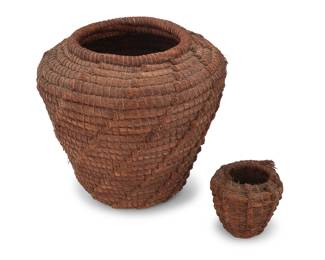 1066 Two Native American pine needle storage baskets Early 20th century A large pine needle basket, together with a smaller version 2 pieces Larger: 19.75" H x 20.75" Dia.; Smaller: 7.25" H x 7.75" Dia. Estimate: $200 - $400