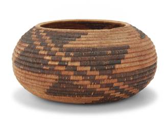 1235 A Pomo basketry bowl Early 20th century; Central California The coiled bowl finely woven with two swirling zig-zag designs issuing from center to rim 2.375" x 5.125" Dia. Estimate: $800 - $1,200