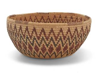 1011 An Isabel Hanson Panamint Shoshone polychrome basket Isabel Hanson (1880-1964, Panamint Shoshone) Early 20th century; Great Basin The coiled basket with partial rim ticking above a rattlesnake design of zigzag diamonds and serration to body, with three fang and forked tongue designs to base 4" H x 9" Dia. Estimate: $800 - $1,200