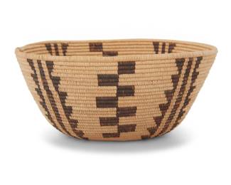 1010 An Emily Bellas Panamint Shoshone basketry bowl Emily Bellas (20th century, Panamint Shoshone) Early 20th century; Great Basin The very finely woven coiled oval bowl with alternating sawtooth columns and checkered columns described as Bulrush geometric designs with yucca trees 2.75" H x 6.25" W x 5.625" D Estimate: $800 - $1,200