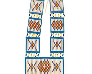 1389 Bernadine & Walter Ten Fingers (1951-2025 & 1950-2012, Sioux) A beaded and quilled women's breastplate, late 20th century Unmarked With geometric quillwork on fabric-lined board, mounted with sinew, beads, and cowrie shells 33.5" H x 13" W Estimate: $200 - $400
