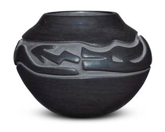 1071 Mary Cain (1915-2010, Santa Clara Pueblo) A blackware pottery jar, late 20th century Incised to underside: Mary Cain / Santa Clara Pueblo With deeply carved Avanyu motif 6.375" H x 8.875" Dia. Estimate: $400 - $600