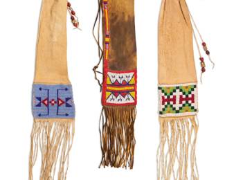 1394 Three Plains beaded hide tobacco bags Mid-20th century and later Each with beaded geometric designs and beaded tassel cinch 3 pieces Longest: 20.5" H x 6" W; Shortest: 17.25" H x 5" W Estimate: $600 - $800