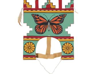 1406 A Hopi polychrome wood butterfly dance tableta Late 20th/early 21st century The polik mana style headdress decorated with butterflies to each side and crested by kiva steps mounted with feathers, with hide and cord strapping With feathers: 17" H x 11.5" W x 0.625" D Estimate: $200 - $400