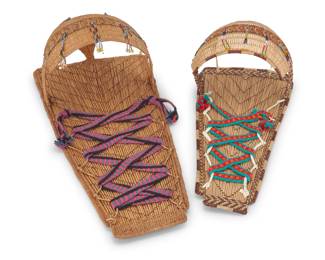 1346 Two Mono basketry cradleboards Mid/late 20th century; Central California Comprising a large twined cradleboard with striped and diagonal banding, with integral curved shaped hood adorned with five bead dangles, and a pink, blue, and red woven yarn binding strap, and a smaller cradleboard with shaped hood, bead dangles, and a green, red, and orange woven binding strap 2 pieces Larger: 29.5" H x 15" W x 10.5" D; Smaller: 24.15" H x 12" W x 9" D Estimate: $200 - $300