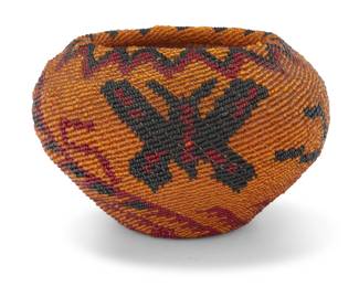 1023 A Washoe beaded pictorial basket Early 20th century; Great Basin The coiled basket with applied glass beads depicting a serrated rim above butterflies and swirling geometric motifs issuing from center 3.75" H x 5.875" Dia. Estimate: $500 - $700