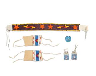 1396 A group of Native American beaded items Late 20th/early 21st century Comprising a sash with stars and lightning bolt motifs, two pairs of arm bands with geometric designs, and a beaded baseball 6 pieces Sash: 31" L; Each larger armband: 4.875" L x 4.5" W; Each smaller: 2.25" L x 3.25" W Estimate: $200 - $400