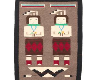 1263 A Navajo pictorial Yei textile Mid/late 20th century, Diné Woven in multicolor wool, depicting two Yei figures with rainbows above and a basket and two feathers below 32.25" H x 24.75" W Estimate: $400 - $600