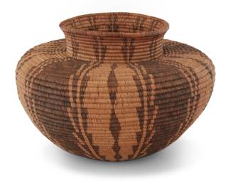 1009 A Panamint Shoshone bottleneck basket Early 20th century; Great Basin The coiled basket with five columns of graduated serration 5.625" H x 8.75" Dia. Estimate: $1,500 - $2,000
