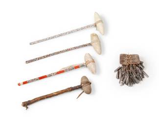 1384 Four Plains style skull crackers 20th century Comprising three beaded shaft clubs and one hide-wrapped club, together with a rattle of cut tin cones 5 pieces Longest: 9.25" H x 6.625" W x 2.875" D; Tin cones: 7" H x 5" W x 6" D Estimate: $300 - $500