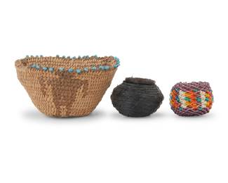 1240 Three miniature Western baskets Early 20th century; Southwest United States Comprising an Akimel O'odham (Pima) coiled figural basket with turquoise glass beads applied to braided rim, a polychrome beaded basket, and a lidded horsehair basket 3 pieces Largest: 1.25" H x 2.375" Dia.; Smallest: 0.75" H x 1" Dia. Estimate: $300 - $500