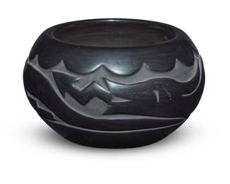 1293 Florence Browning (b. 1931, Santa Clara Pueblo) A blackware pottery jar, late 20th century Signed to underside: Florence Browning / Santa Clara Pueblo With deeply incised Avanyu motif 3.875" H x 6.875" Dia. Estimate: $200 - $400