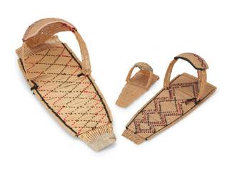 1045 Three Paiute basketry cradleboards Mid/late 20th century; Great Basin In graduated sizes, each woven with yarn in geometric designs 3 pieces Largest: 30" L x 10.5" W x 8.625" D; Smallest: 9.875" L x 4.125" W x 3.875" D Estimate: $400 - $600