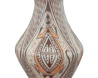 1299 Sylvia [Featherwoman] Naha (1951-1999, Hopi-Tewa) A polychrome pottery jar, late 20th century Signed to underside with artist's feather cipher and: S The three-color jar with red and brown lizard motifs alternating with hachured geometric motifs on a white slip ground 6.25" H x 4.125" Dia. Estimate: $200 - $400