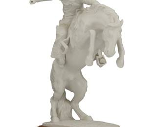 1157 After Frederic Remington (1861-1909) A Gorham porcelain figure after "Bronco Buster" (1895), late 20th century With factory marks to underside: THIS SELECTION INSPIRED BY / Frederic Remington's / FAMOUS BRONZE SCULPTURE / "Bronco Buster" / FROM THE GIFT WORLD OF GORHAM Raised on a wood plinth Overall: 13.125" H x 9.25" W x 5.125" D Estimate: $100 - $200