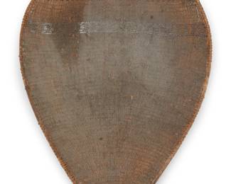 1050 A Paiute winnowing tray Early 20th century; Great Basin With two bands, one of floating chevrons 4" H x 25" W x 18.5" D Estimate: $100 - $200